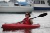 Katherine Sullivan paddles among the bigger boats in the inner harbor as Windjammers arrive. SUE MELLO/Boothbay Register