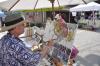John Seitzer painted before the footbridge as crowds milled around Artists' Alley Tuesday, June 25. Artists' Alley is one of the first events of the 51st Windjammer Days Festival. BEN BULKELEY/Boothbay Register 