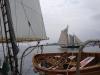 The Nathaniel Bowditch sails in front of Burnt Island, with a lifeboat of the Lewis R. French hangs off the davits of the Lewis R. French in the foreground. RYAN LEIGHTON/Boothbay Register