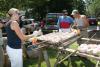 Sandy Wheeler and John Leonard prep the chicken for the grill. KEVIN BURNHAM/Boothbay Register