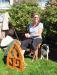 Nanne Kennedy sits with her  faithful border collie spinning wool at the waterfront park. RYAN LEIGHTON/ Boothbay Register.