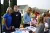 Kristy Anderson, far left, fills in for event organizer Sarah Blackman, who couldn’t attend because she was injured on Saturday. Next to Anderson is Blackman’s daughter, Victoria. Also helping is Kyra, right. NICOLE LYONS/Boothbay Register