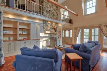 Living room,fireplace, field stone, french doors, hardwood floors, custom builtins