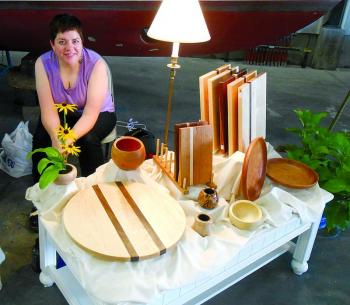 Amé Mundy of West Boothbay Harbor, who designs under the Wooden Whimsy name, diplays some of her functional wood art at Lincoln Art Festival's Arts & Yachts show held at the Boothbay Region Boatyard. GARY DOW/Boothbay Register